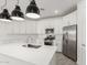 Bright kitchen showcases white cabinetry, stainless steel appliances, and stylish pendant lighting at 4051 S Galaxy Ln, Mesa, AZ 85212