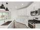 Updated kitchen with stainless steel appliances, subway tile backsplash, and bright quartz countertops at 4051 S Galaxy Ln, Mesa, AZ 85212