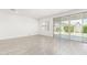 Bright living room with neutral tile flooring, large windows and sliding glass doors at 4051 S Galaxy Ln, Mesa, AZ 85212