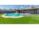 Well-maintained backyard featuring a swimming pool, spa, and lush green lawn at 4137 E Sells Dr, Phoenix, AZ 85018
