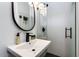 Modern bathroom featuring a black faucet and framed mirror, with tiled floors and shower at 4137 E Sells Dr, Phoenix, AZ 85018