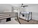 Bright bedroom featuring two bunk beds, ceiling fan, and window with natural light at 4137 E Sells Dr, Phoenix, AZ 85018