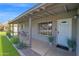 Covered front porch with a welcome mat, green plants, and a seating area offers a welcoming entrance at 4137 E Sells Dr, Phoenix, AZ 85018