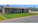 Charming single-story home features a well-maintained lawn and a cozy seating area in the front yard at 4137 E Sells Dr, Phoenix, AZ 85018