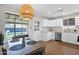 Eat-in kitchen with bright lighting, white cabinets, stainless steel appliances, and a backyard view at 4137 E Sells Dr, Phoenix, AZ 85018