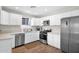 Bright kitchen featuring white cabinets, stainless steel appliances, and a modern design at 4137 E Sells Dr, Phoenix, AZ 85018