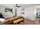 Open living room with a leather sofa, stylish decor, and access to other areas of the house at 4137 E Sells Dr, Phoenix, AZ 85018