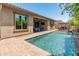Beautiful backyard featuring a sparkling pool, covered patio, and manicured landscaping at 4141 E Morrison Ranch Pkwy, Gilbert, AZ 85296