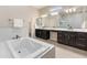 Luxurious bathroom with marble-like bathtub, dual vanities, and modern fixtures for a spa experience at 4141 E Morrison Ranch Pkwy, Gilbert, AZ 85296