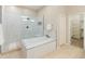 Elegant bathroom featuring a tub, glass shower, and modern fixtures for ultimate relaxation at 4141 E Morrison Ranch Pkwy, Gilbert, AZ 85296
