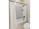 Clean bathroom featuring a tub with stylish tile surround and a modern showerhead at 4141 E Morrison Ranch Pkwy, Gilbert, AZ 85296