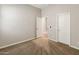 Spacious bedroom with an open doorway, plush carpeting, and ample natural light at 4141 E Morrison Ranch Pkwy, Gilbert, AZ 85296
