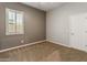 Inviting bedroom with large window, neutral walls, and plush carpeting at 4141 E Morrison Ranch Pkwy, Gilbert, AZ 85296