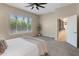 Relaxing primary bedroom featuring a ceiling fan, neutral walls, and a view of the outdoors at 4141 E Morrison Ranch Pkwy, Gilbert, AZ 85296