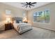 Bright bedroom with a gray bed, bedside tables, and large windows providing natural light at 4141 E Morrison Ranch Pkwy, Gilbert, AZ 85296