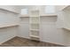 Walk-in closet with shelving, rods, and good lighting for efficient organization of clothes and accessories at 4141 E Morrison Ranch Pkwy, Gilbert, AZ 85296