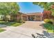 Beautiful single-story home featuring a paver driveway, a two-car garage, stone accents and mature landscaping at 4141 E Morrison Ranch Pkwy, Gilbert, AZ 85296
