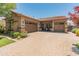 Attractive exterior elevation featuring a tile roof, paver driveway, two-car garage, and a covered porch at 4141 E Morrison Ranch Pkwy, Gilbert, AZ 85296