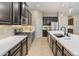 Beautiful kitchen features stainless steel appliances, quartz countertops and dark cabinets, perfect for the home chef at 4141 E Morrison Ranch Pkwy, Gilbert, AZ 85296