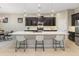 Gourmet kitchen with marble countertops, dark wood cabinets and stainless appliances is perfect for entertaining at 4141 E Morrison Ranch Pkwy, Gilbert, AZ 85296