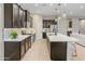 Beautiful kitchen features stainless steel appliances, quartz countertops and dark cabinets, great for entertaining at 4141 E Morrison Ranch Pkwy, Gilbert, AZ 85296