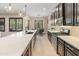 Beautiful kitchen features stainless steel appliances, quartz countertops and dark cabinets, great for entertaining at 4141 E Morrison Ranch Pkwy, Gilbert, AZ 85296