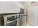 Modern laundry room with sleek appliances, ample storage cabinets, and a convenient layout at 4141 E Morrison Ranch Pkwy, Gilbert, AZ 85296