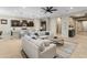 Spacious living room with a kitchen view, large windows, comfortable sofas, and modern decor at 4141 E Morrison Ranch Pkwy, Gilbert, AZ 85296