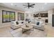 Inviting living room showcasing a large sectional sofa, a modern ceiling fan, and seamless flow to kitchen at 4141 E Morrison Ranch Pkwy, Gilbert, AZ 85296