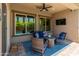 Relaxing covered patio with comfortable seating, ceiling fan, and outdoor TV for entertaining at 4141 E Morrison Ranch Pkwy, Gilbert, AZ 85296