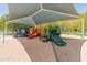 Colorful playground featuring multiple slides, climbing structures, and covered area for enjoyment at 4141 E Morrison Ranch Pkwy, Gilbert, AZ 85296