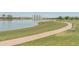 Scenic pond with walking path and distant mountain views, offering a tranquil outdoor space at 4141 E Morrison Ranch Pkwy, Gilbert, AZ 85296