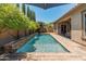 Private pool area featuring a waterfall, lush landscaping, and comfortable outdoor seating at 4141 E Morrison Ranch Pkwy, Gilbert, AZ 85296