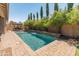 Stunning pool with a waterfall feature, surrounded by lush landscaping and a brick patio at 4141 E Morrison Ranch Pkwy, Gilbert, AZ 85296