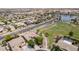 Aerial view shows home with a landscaped yard neighboring a greenbelt, walking paths, and a tranquil neighborhood lake at 41804 W Carlisle Ln, Maricopa, AZ 85138