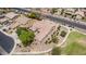 Aerial view of a landscaped single-Gathering home with a tile roof near a road with lush desert landscaping at 41804 W Carlisle Ln, Maricopa, AZ 85138