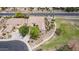 Aerial view of a single Gathering home near a greenbelt, meticulously landscaped with mature trees and lush desert landscaping at 41804 W Carlisle Ln, Maricopa, AZ 85138