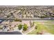 Aerial shot shows a neighborhood with solar panels, greenbelts, and walking paths alongside a home with mature landscaping at 41804 W Carlisle Ln, Maricopa, AZ 85138