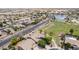 Aerial view shows home bordering a lush greenbelt and walking paths, with a tranquil neighborhood lake nearby at 41804 W Carlisle Ln, Maricopa, AZ 85138