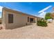 Spacious backyard with low-maintenance landscaping and a covered patio at 41804 W Carlisle Ln, Maricopa, AZ 85138