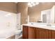 Well-lit bathroom featuring a double sink vanity and a shower-tub combination at 41804 W Carlisle Ln, Maricopa, AZ 85138