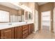 Bathroom featuring double sinks, wood cabinets, and tile flooring at 41804 W Carlisle Ln, Maricopa, AZ 85138