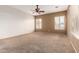 Large bedroom with a ceiling fan, carpet flooring, and natural light at 41804 W Carlisle Ln, Maricopa, AZ 85138