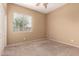 Bedroom featuring carpeted flooring and a window at 41804 W Carlisle Ln, Maricopa, AZ 85138