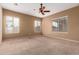 Spacious bedroom featuring neutral walls, plush carpeting, and a ceiling fan at 41804 W Carlisle Ln, Maricopa, AZ 85138