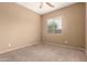 Bedroom featuring carpeted flooring and a window with natural light at 41804 W Carlisle Ln, Maricopa, AZ 85138