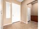 Entryway featuring neutral-colored walls, tile flooring, and a bright white front door at 41804 W Carlisle Ln, Maricopa, AZ 85138