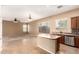 Open kitchen with island, stainless appliances, tile floors, and access to the living area at 41804 W Carlisle Ln, Maricopa, AZ 85138