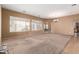 Spacious living room with carpet flooring, natural light, and a chandelier at 41804 W Carlisle Ln, Maricopa, AZ 85138