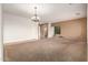 Spacious living room featuring neutral paint, chandelier, and carpet flooring at 41804 W Carlisle Ln, Maricopa, AZ 85138